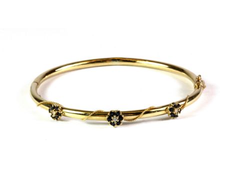 A pretty 9ct yellow gold sapphire and diamond set bangle.