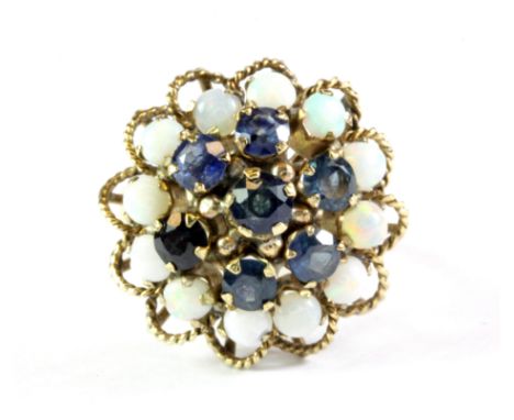 A 14ct yellow gold (stamped 14k) opal and sapphire set large cluster ring, Dia. 2cm, (L.5).