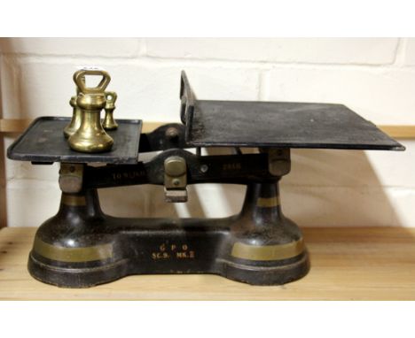 A large early 20th century Post Office scale and weights, W. 52cm.