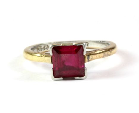 A 22ct yellow gold and platinum ruby set solitaire ring, (L).