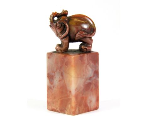 A small mid 20th century Chinese carved hardstone seal mounted with a mythical elephant figure, H. 7.5cm.