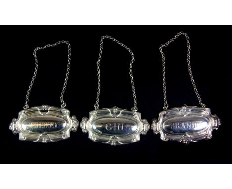 Three hallmarked silver decanter labels.