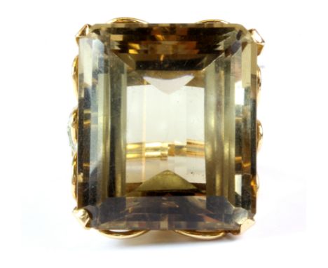 A yellow metal (tested 18ct gold) ring set with a very large step cut smokey quartz, 2.6 x 2.2 x 1.4cm, (P.5).