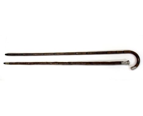 A hallmarked silver mounted walking stick and sterling silver decorated walking cane.