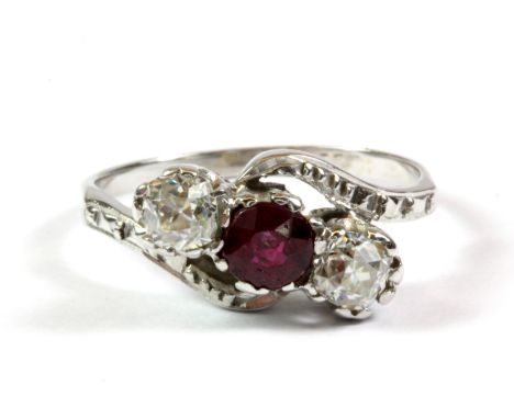 A white metal (tested minimum 9ct gold) diamond and ruby ring, (J.5).