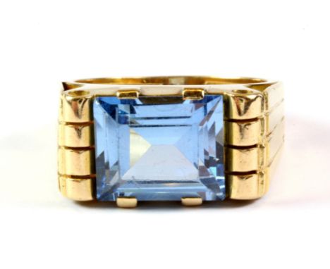 A yellow metal (tested 18ct gold) ring set with a step cut blue topaz, (R ).