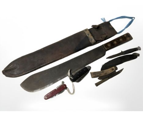 A 20th century military issue machete, in leather sheath, together with Swiss army knife, a military jack knife, trench art k