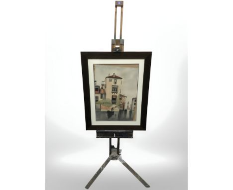 A wooden easel and a watercolour painting depicting a canal scene.