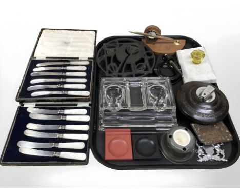 A group of desk stands, table lighter, French cast iron kettle stand, two boxed sets of butter knives etc 