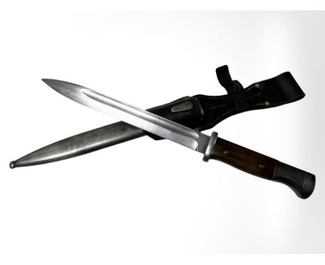 A German WWII K98 Mauser bayonet, 25cm blade stamped 42cof (1942 date code Carl Eickhorn), in scabbard with leather frog (sca