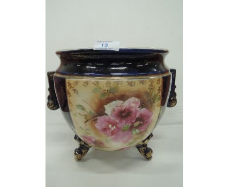 A vintage ceramic planter with three footed base
