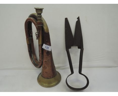A vintage copper and brass hunters or military bugle with aged patina and accompanying sheep shears