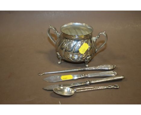 AN EASTERN WHITE METAL TWIN HANDLED CUP TOGETHER WITH A SILVER HANDLED BUTTON HOOK, FISH KNIVES ETC. 