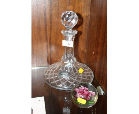 A CUT GLASS DECANTER WITH HALLMARKED SILVER SHERRY LABEL TOGETHER WITH A FLORAL GLASS PAPERWEIGHT 