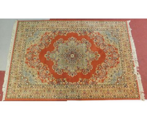 A Tabriz carpet with central floral medallion on rouge ground within floral multi-border. 200x315cm 