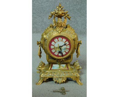 A French style brass cased mantel clock with painted face. (with pendulum and key). H.29cm 