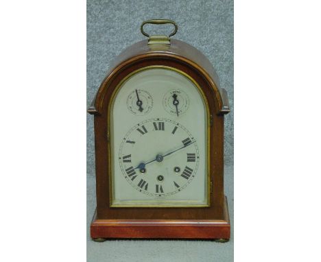 An antique Wurtemburg Westminster chime mahogany cased bracket clock. With brass carrying handle and movement. The face has t