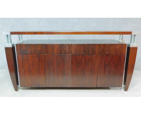A contemporary teak and metal bound console cabinet fitted with drawers and cupboards to the base. H.89 W.180 D.50cm 
