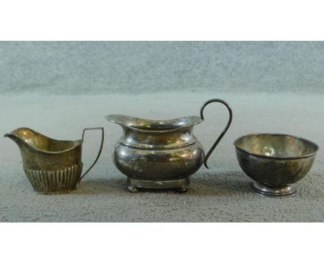 Three sterling silver items. Including an Art Deco milk jug on four button feet, hallmarked: EV for Viner's Ltd, Sheffield, 1