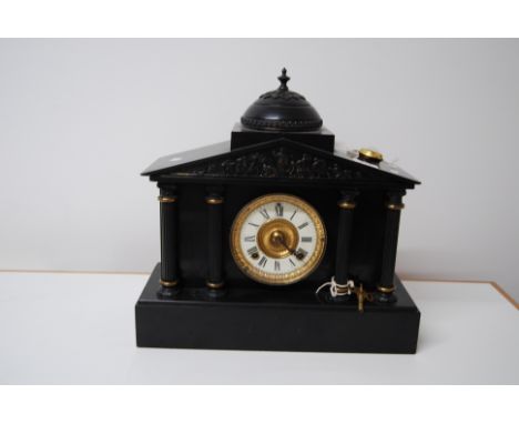 VICTORIAN POLISHED BLACK SLATE ARCHITECTURAL CLOCK WITH A RELIEF PANEL DEPICTING ROMAN OR GREEK SOLDIERS, WITH KEY & PENDULUM