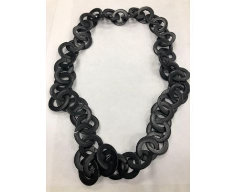 CHRISTIAN DIOR GEM SET NECKLET, the pendant set with green and white gems; along with another necklace, possibly bog oak (2)