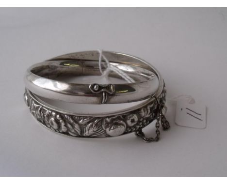 A finely embossed wide solid silver bangle also another   plain silver bangle  33.5g      