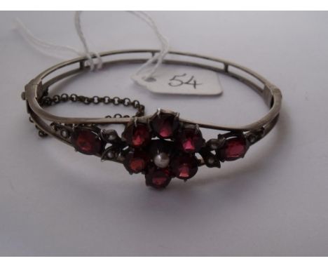 An attractive garnet and pearl set silver bangle 10.6g inc  