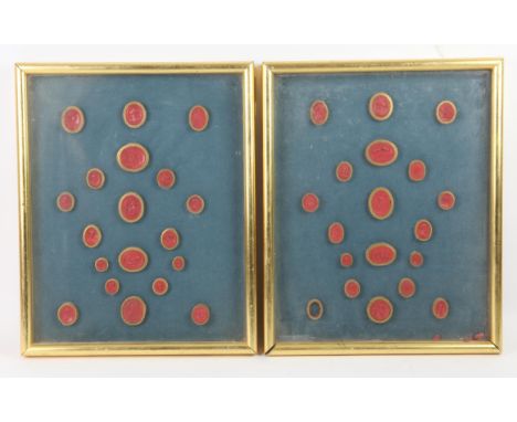 A collection of thirty seven 19th century "Grand Tour" red wax intaglio seals, each in gilt paper binding, mounted in two gil