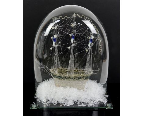 Late 19th century glass model frigger of a ship with sailors in the rigging, under glass dome, dome 38cm high,