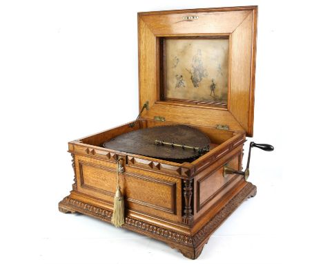 Oak cased Nicole Freres Polyphon, with 'Regina' movement numbered 33884, 39.5 (15 3/4 inch) diameter discs, the domed case wi