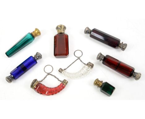 Three Victorian cut glass double ended scent bottles with white metal lids, two in ruby glass and one in blue glass, (one wit
