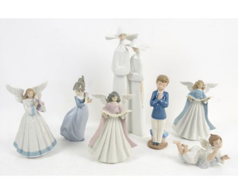 Three Lladro figures of angels, original boxes (nos. 5830, 5719 and 5831), a figure group of nuns (04611), a figure of an ang