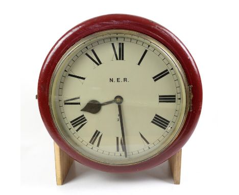 North Eastern Railway maroon painted wall clock, the Roman dial marked N.E.R. R20, mounted to wooden bracket with additional 