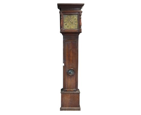 18th century oak longcase clock, the protruding cornice over baluster pilasters enclosing a matted brass dial with mask spand