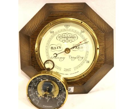 An oak wall barometer by Short and Mason London, 24 x 24 cm and a smaller example in brass. Not available for in-house P&amp;