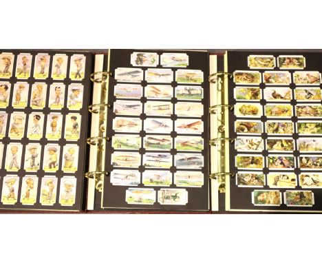 Forty complete mint sets of cigarette card reprints in three Card Collectors Society album binders and a quantity of empty pa