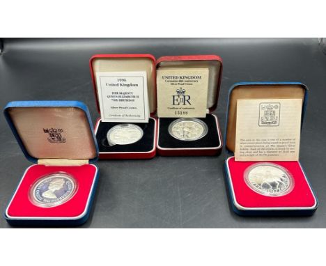 A selection of four silver proof crown coins, two Silver Jubilee, 40th anniversary of the Coronation and Queen Elizabeth II's