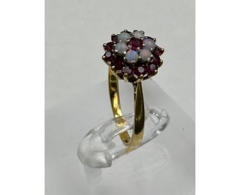 An 18ct gold opal and ruby cluster ring, approximate size N