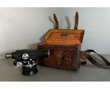 A Theodolite by E.R.Watts and Sons Ltd in a A Clarkson and Co brown leather case with tripod and measuring stick