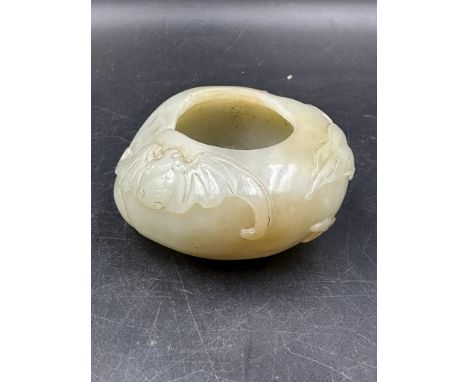 A Chinese jade bowl, approximate 7cm in diameter and 3cm high with floral decoration.