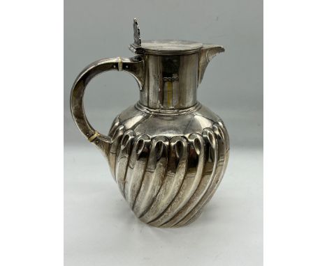 A silver pitcher (390g) by William Hutton & Sons (Edward Hutton) hallmarked for London 1889.