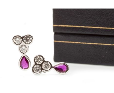 PAIR OF RUBY AND DIAMOND EARRINGS, each set with a pear shaped ruby and three round brilliant cut diamonds, the rubies totall