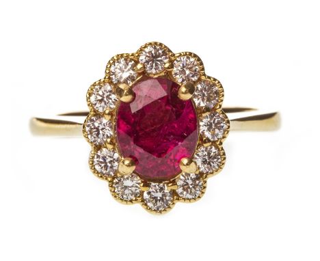 RUBY AND DIAMOND CLUSTER RING, the oval ruby within a halo of round brilliant cut diamonds totalling approximately 0.28 carat