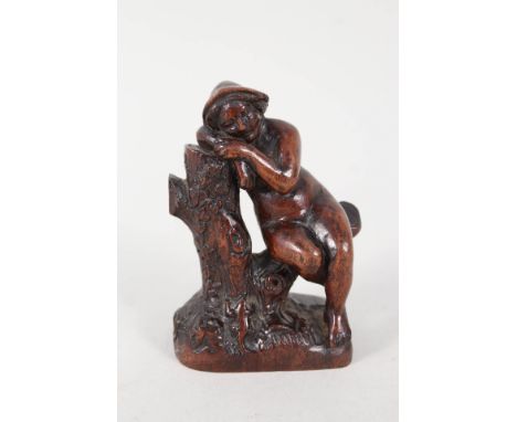 A 19th Century carving of a naked woman asleep upon a tree trunk, height 4 1/2"