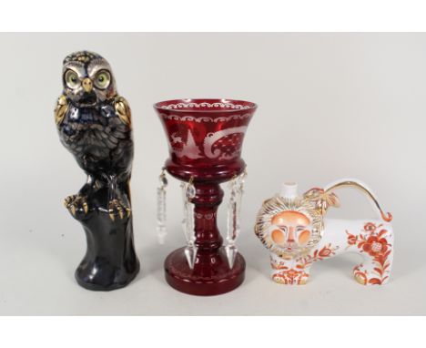 A Victorian ruby flashed table lustre with deer and bird decoration, a Russian lion flask plus a pottery black and gilt eagle