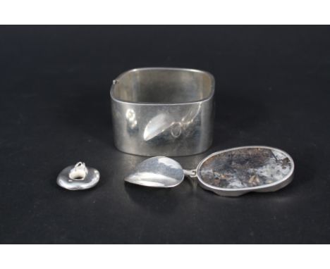 Three silver pendants, one set with large stone and a silver cuff bangle