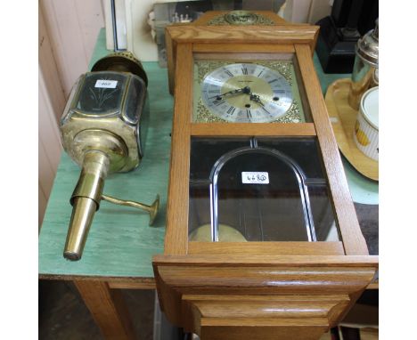 A brass carriage lamp plus a modern striking wall clock