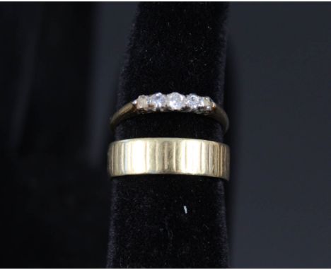 An 18ct gold wedding band plus an 18ct gold diamond ring (two stones missing)