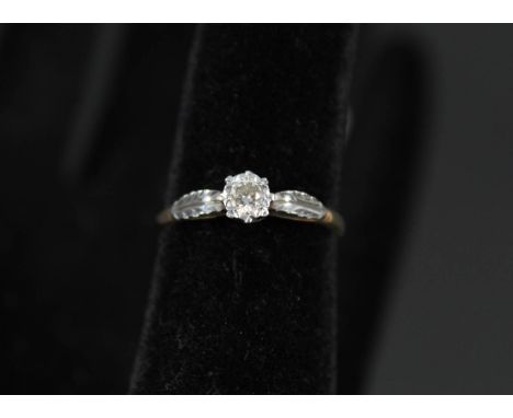 An 18ct gold and platinum illusion set solitaire diamond ring, size N 1/2