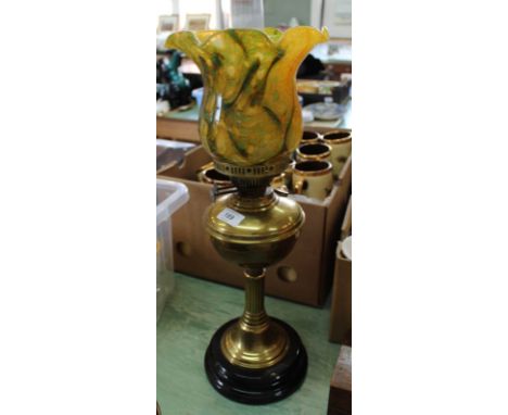 A brass column oil lamp with multi coloured shade